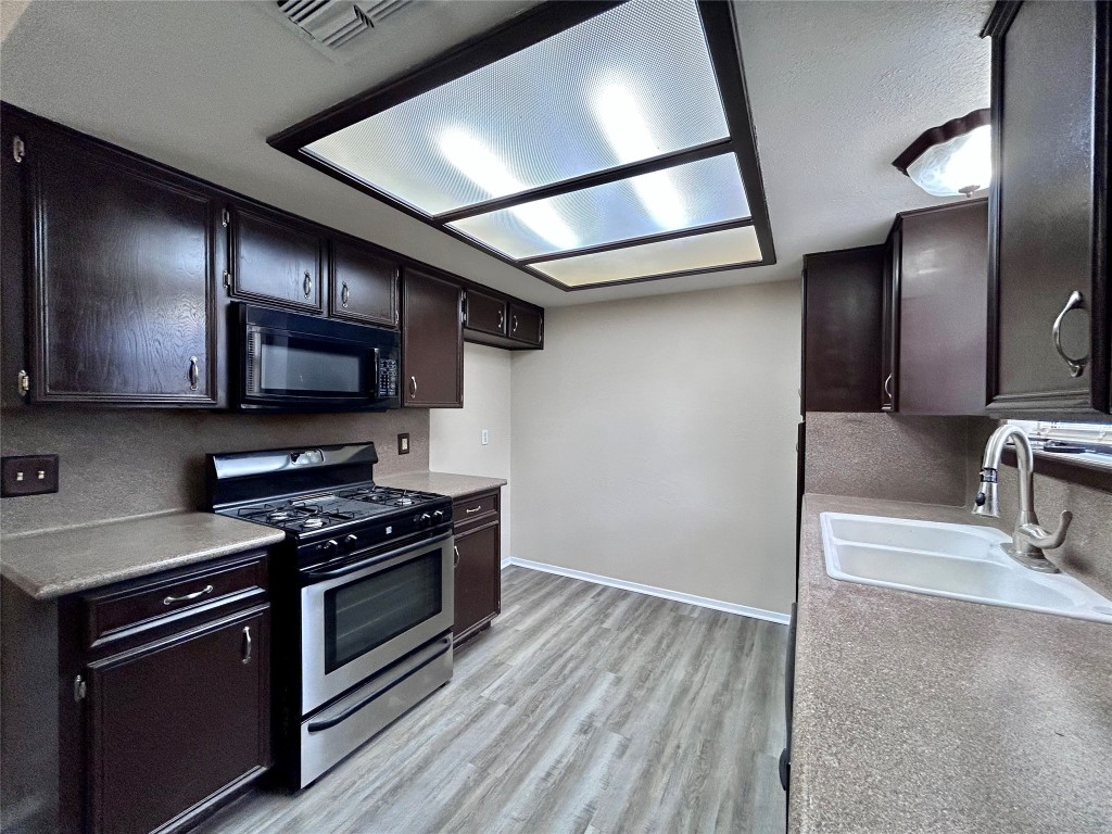 906 Spring Tree Street Round Rock, TX 78681 - Photo 9 of 18 a kitchen with stainless steel appliances granite countertop a stove and a sink