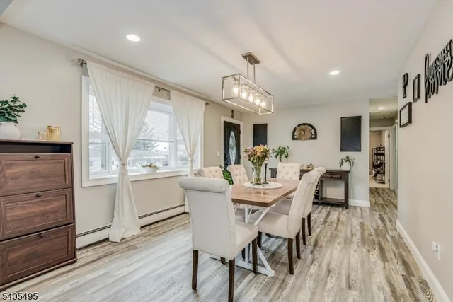 a view of a dining room with furniture and wooden floor