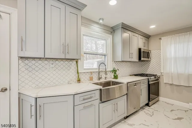 a kitchen with a sink stove and cabinets