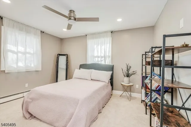 a bedroom with a bed mirror and window