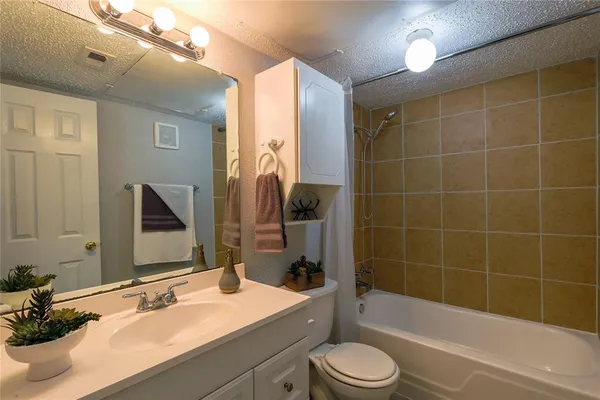 a bathroom with a sink a toilet and bathtub