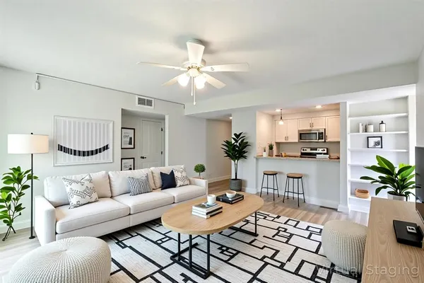 a living room with furniture potted plant and a table