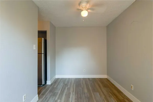 an empty room with wooden floor and closet
