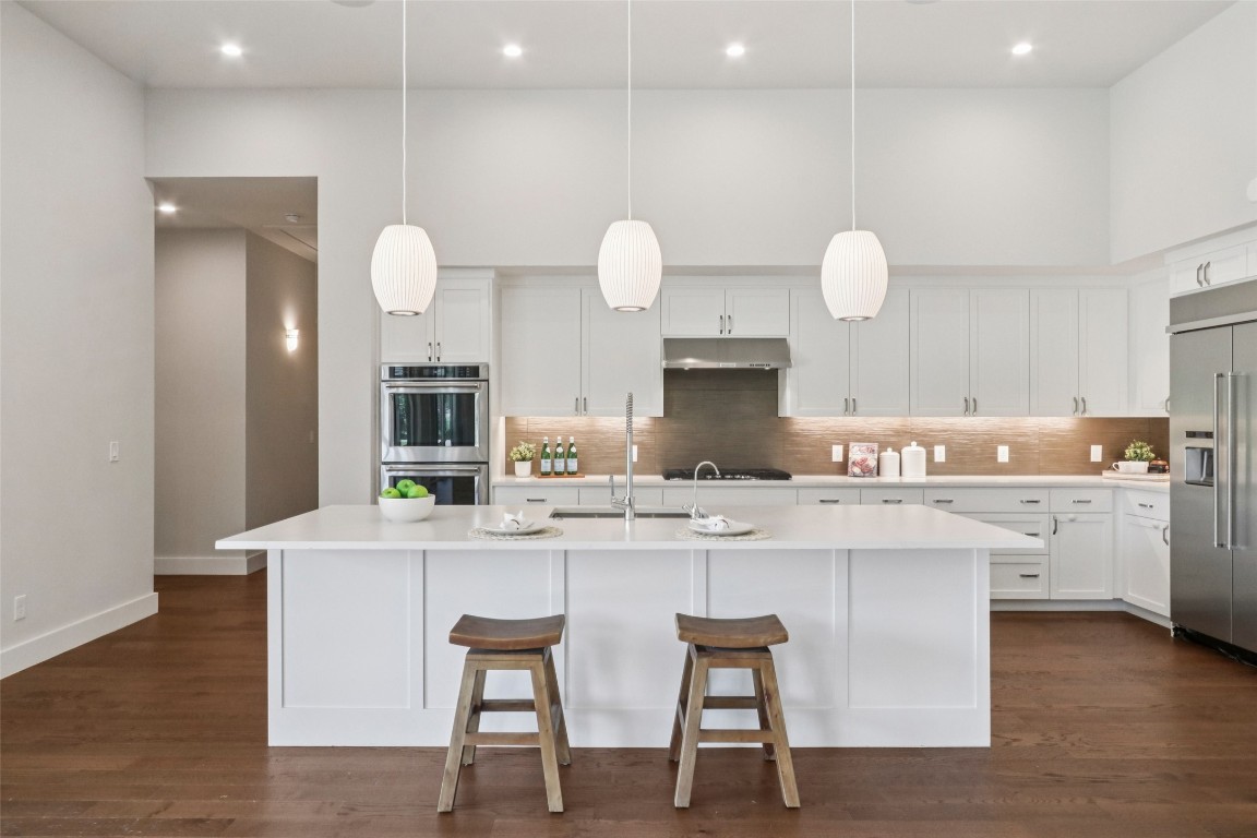 2404 Sailboat Pass Spicewood, TX 78669 - Photo 10 of 39 a kitchen with white cabinets and sink