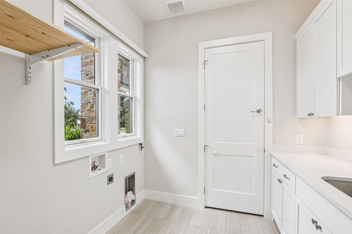 2404 Sailboat Pass Spicewood, TX 78669 - Photo 27 of 39 a view of empty room with window and wooden floor