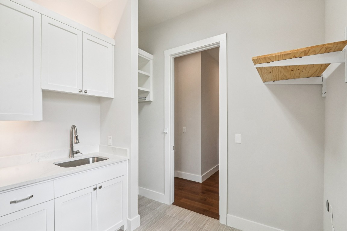 2404 Sailboat Pass Spicewood, TX 78669 - Photo 28 of 39 a kitchen with a sink and cabinets