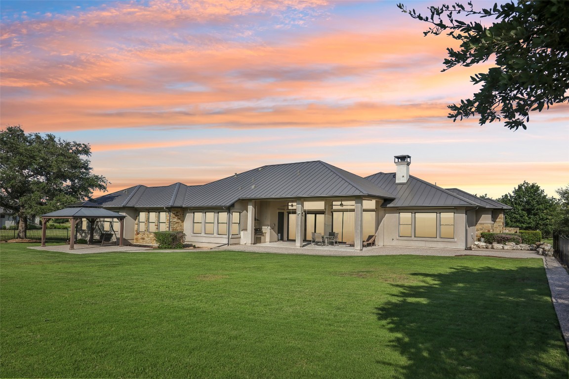 2404 Sailboat Pass Spicewood, TX 78669 - Photo 31 of 39 a front view of a house with garden