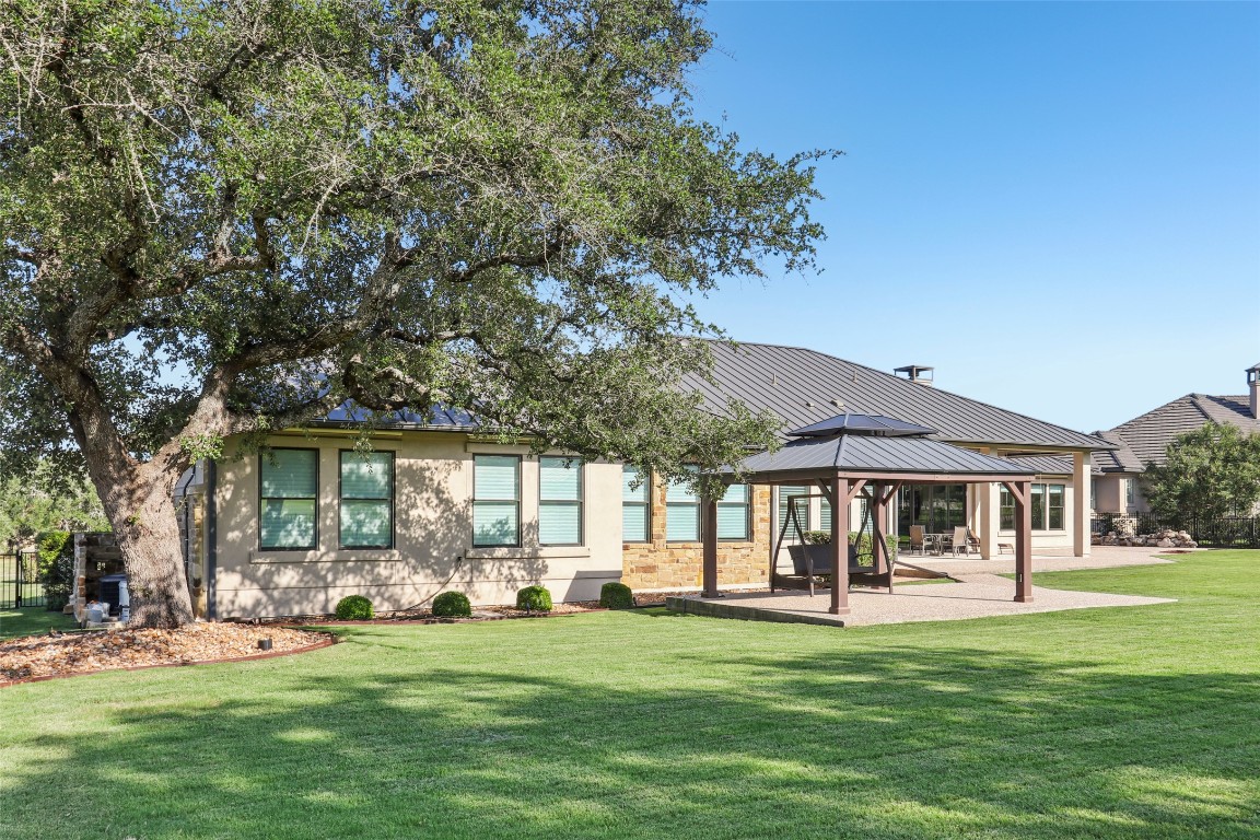 2404 Sailboat Pass Spicewood, TX 78669 - Photo 32 of 39 a front view of a house with a garden