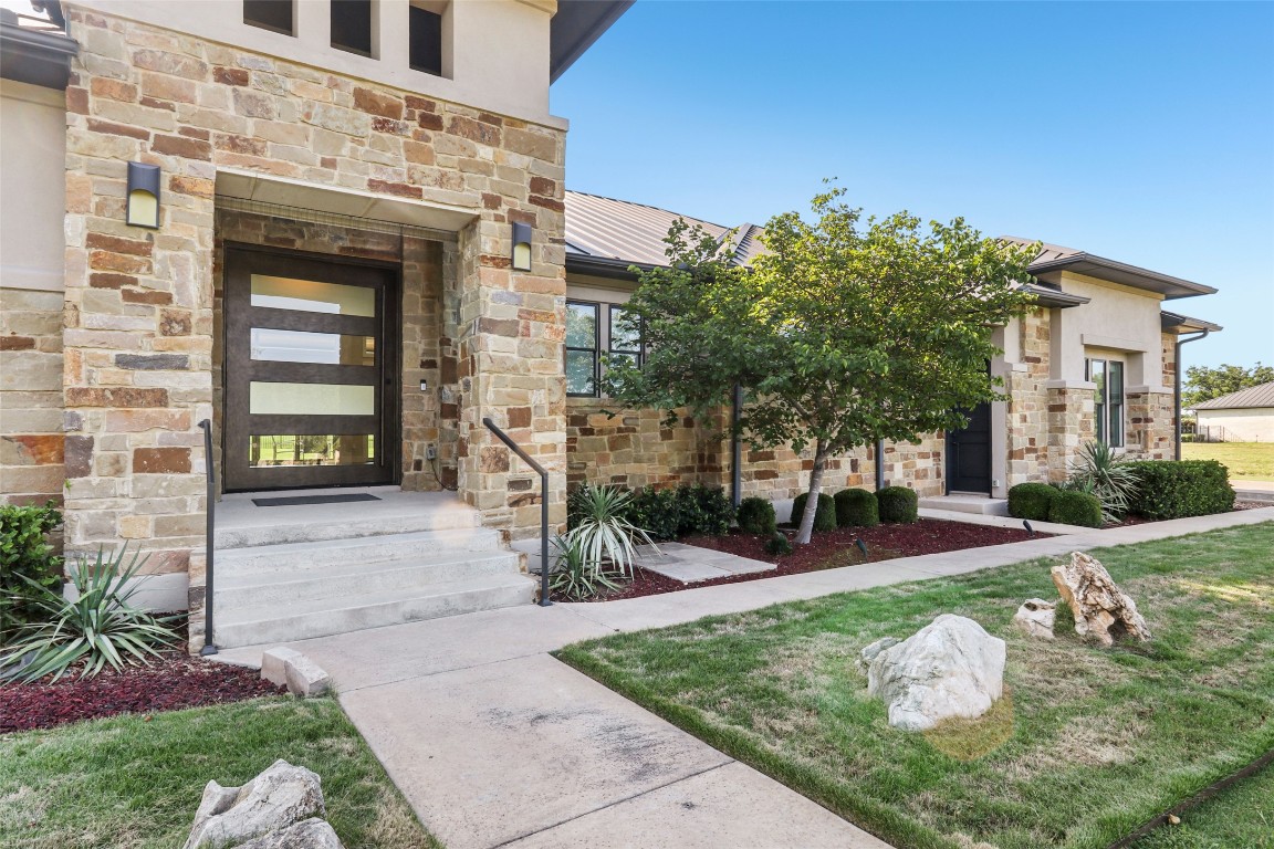 2404 Sailboat Pass Spicewood, TX 78669 - Photo 4 of 39 front view of a house with a yard