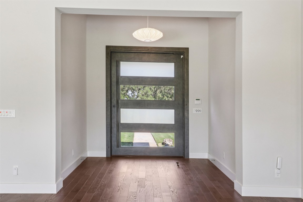2404 Sailboat Pass Spicewood, TX 78669 - Photo 5 of 39 a view of a hallway with wooden floor and a window