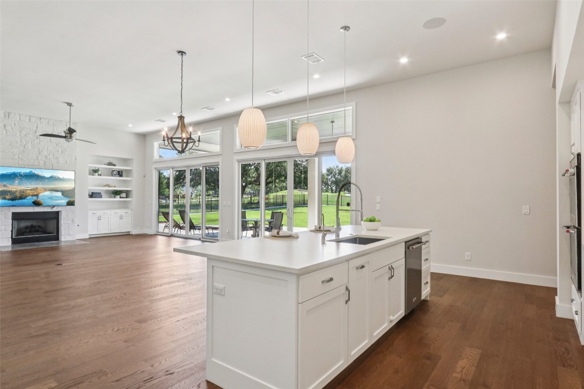 2404 Sailboat Pass Spicewood, TX 78669 - Photo 8 of 39 a kitchen with a sink stove and wooden floor