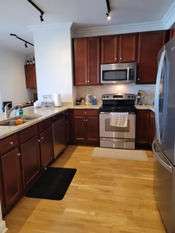 a kitchen with stainless steel appliances granite countertop a sink and a stove