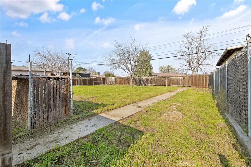 412 East Fairview Road Bakersfield, CA 93307 - Photo 24 of 28 a view of a backyard with wooden fence