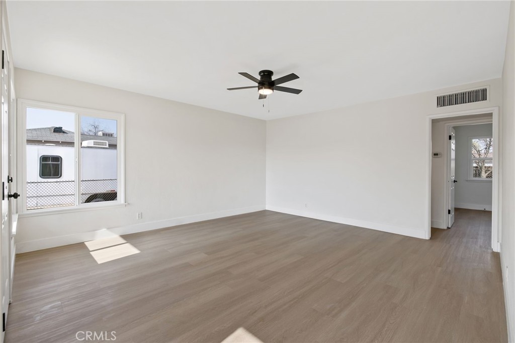 412 East Fairview Road Bakersfield, CA 93307 - Photo 6 of 28 wooden floor in an empty room with a window