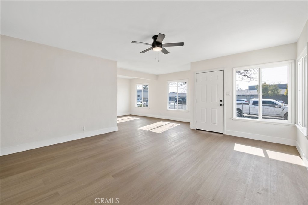 412 East Fairview Road Bakersfield, CA 93307 - Photo 8 of 28 wooden floor in an empty room with a window
