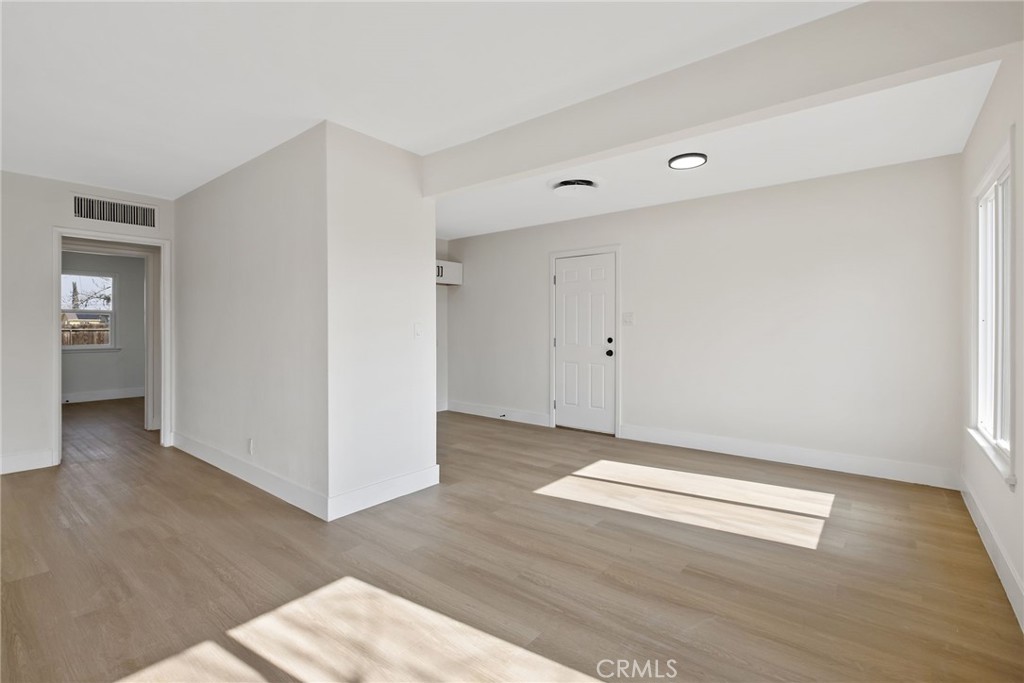 412 East Fairview Road Bakersfield, CA 93307 - Photo 10 of 28 an empty room with wooden floor