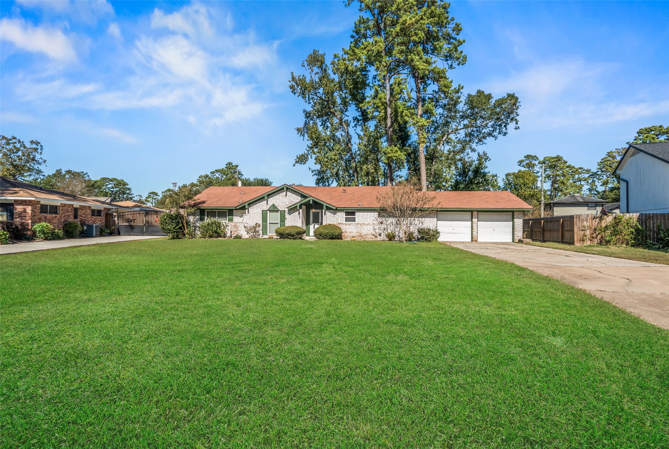 a view of house with garden space and sitting area