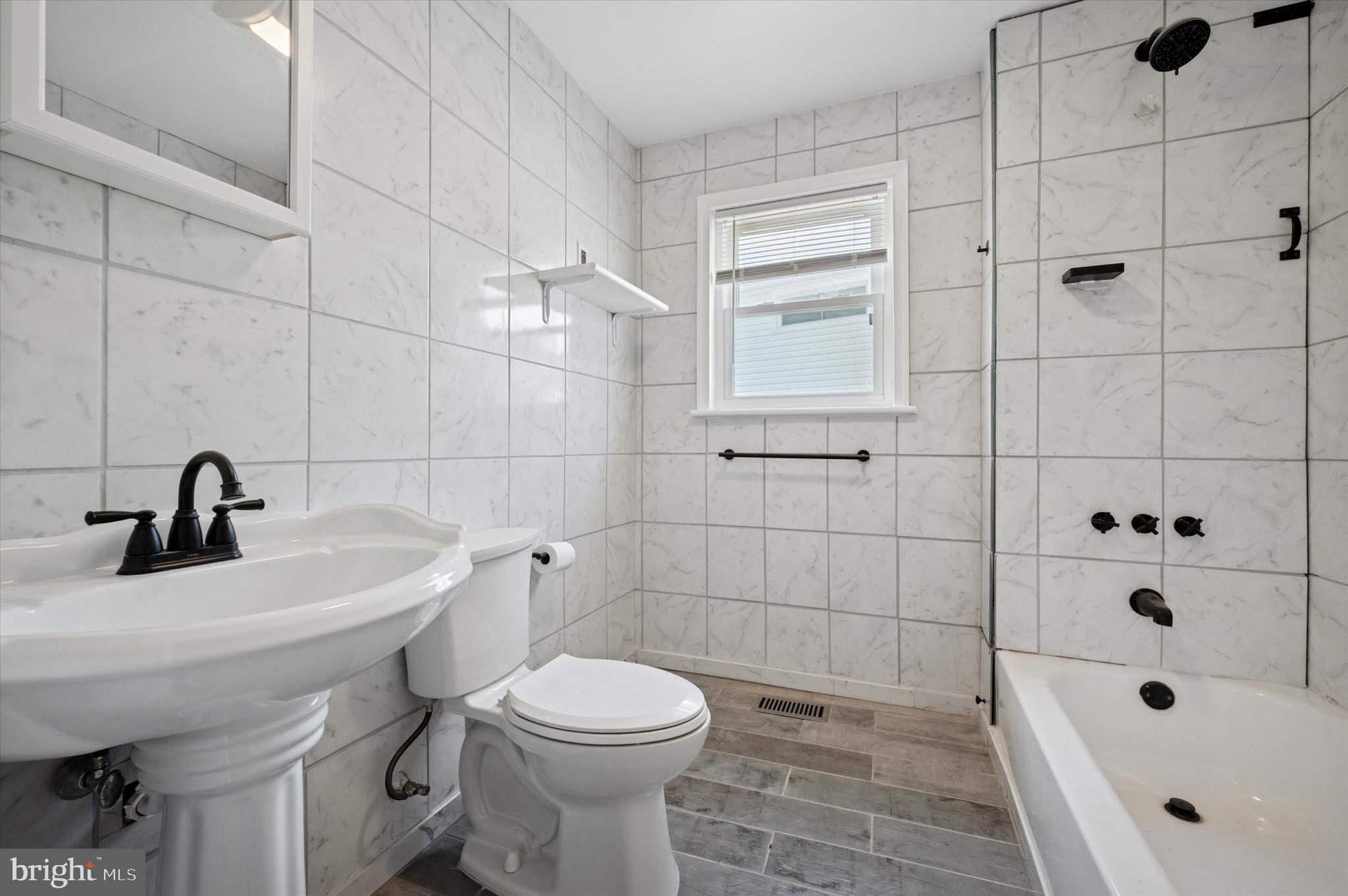 709 Chandler Street Philadelphia, PA 19111 - Photo 16 of 31 a bathroom with a sink a toilet and shower