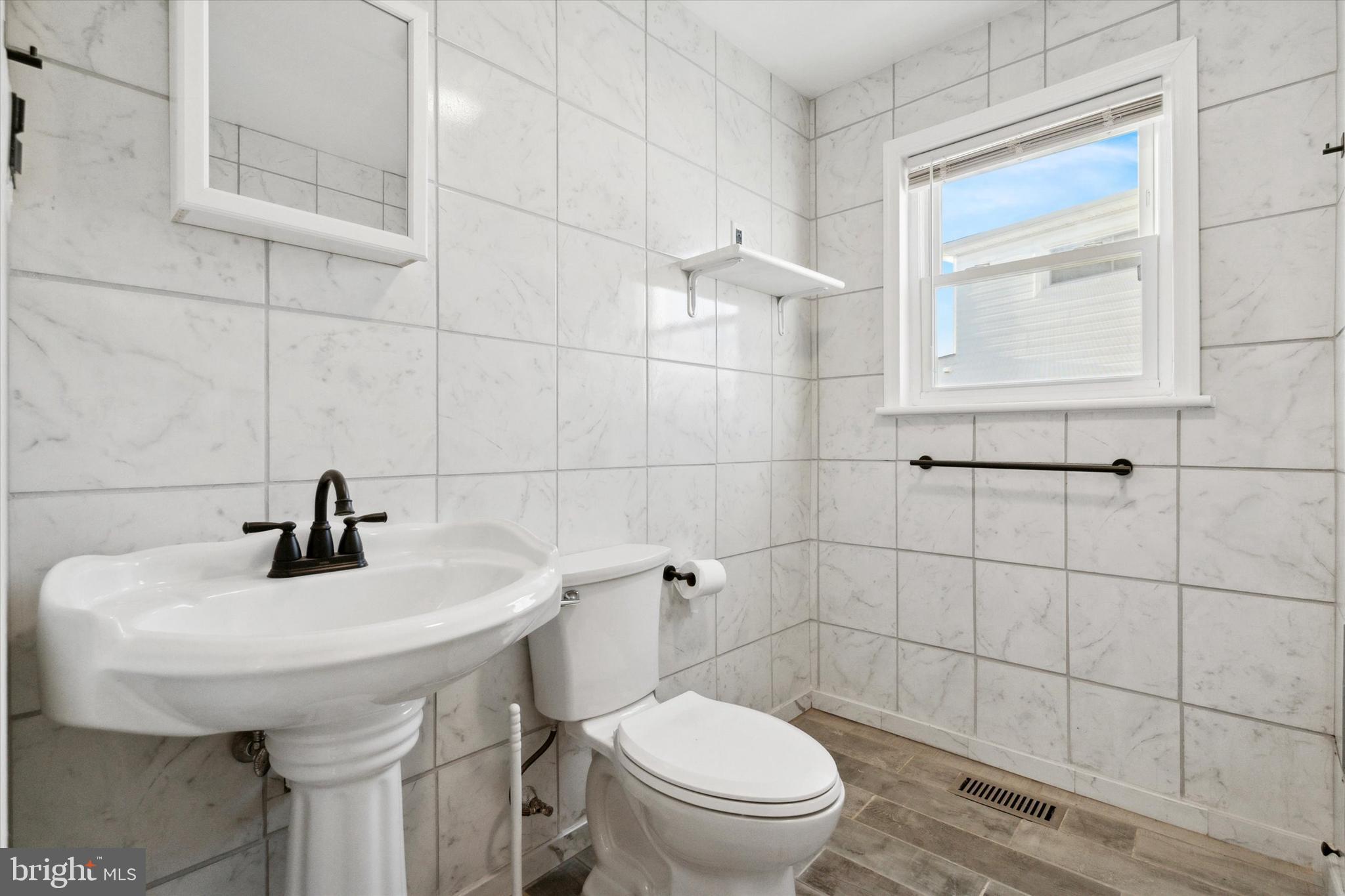709 Chandler Street Philadelphia, PA 19111 - Photo 17 of 31 a bathroom with a sink toilet and mirror