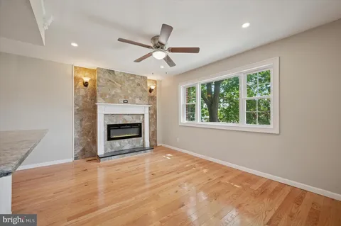 a view of an empty room with a fireplace and a window