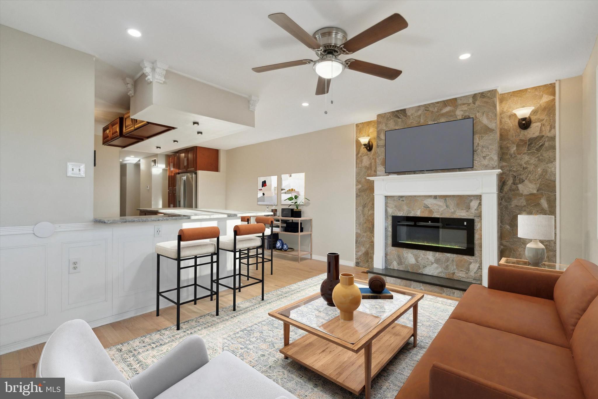 709 Chandler Street Philadelphia, PA 19111 - Photo 6 of 31 a living room with furniture a fireplace and a flat screen tv