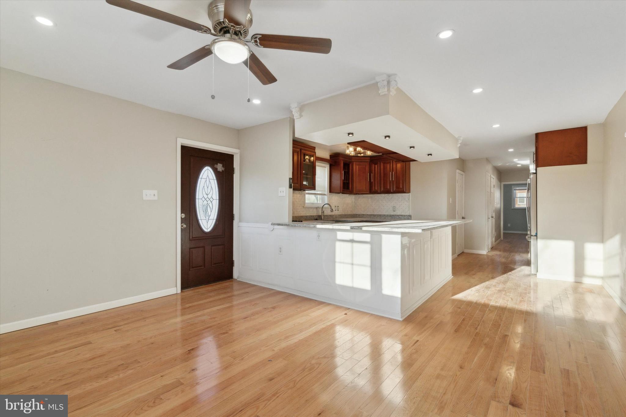 709 Chandler Street Philadelphia, PA 19111 - Photo 7 of 31 a large kitchen with stainless steel appliances kitchen island a large counter top and a wooden floor