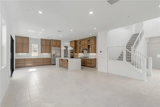 a open kitchen with white cabinets and white appliances
