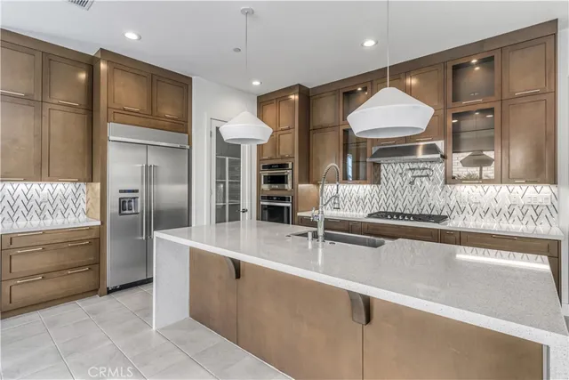 a kitchen with stainless steel appliances granite countertop a refrigerator and a sink