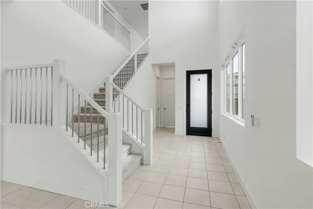 a view of a hallway with entryway and stairs