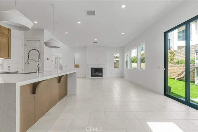 a large kitchen with stainless steel appliances granite countertop a large counter top a stove and a refrigerator