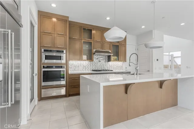a kitchen with stainless steel appliances granite countertop a sink and cabinets