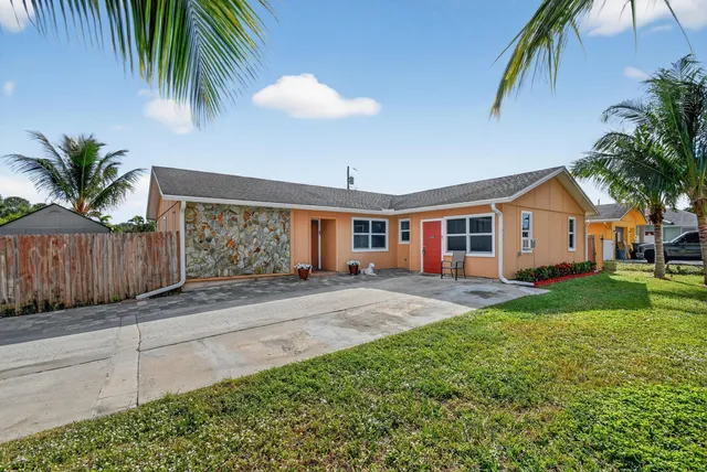 a front view of house with yard and outdoor seating