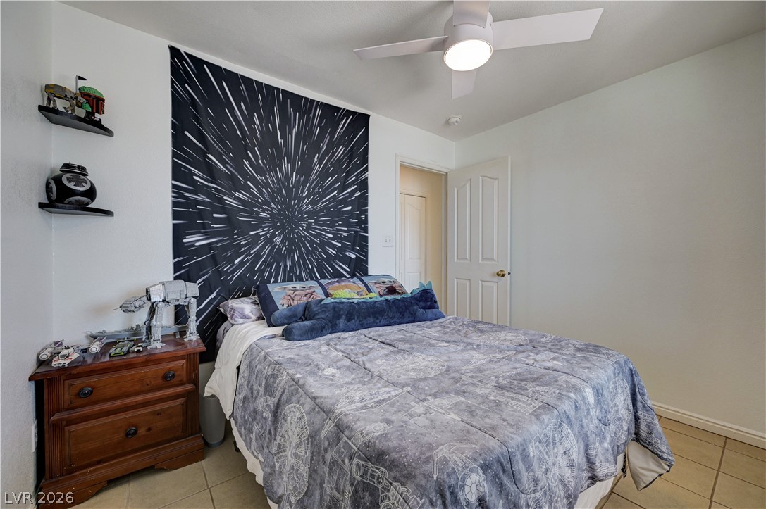 1272 Liston Avenue Logandale, NV 89021 - Photo 30 of 61 Well-lit room featuring tile flooring and a ceiling fan for comfort.