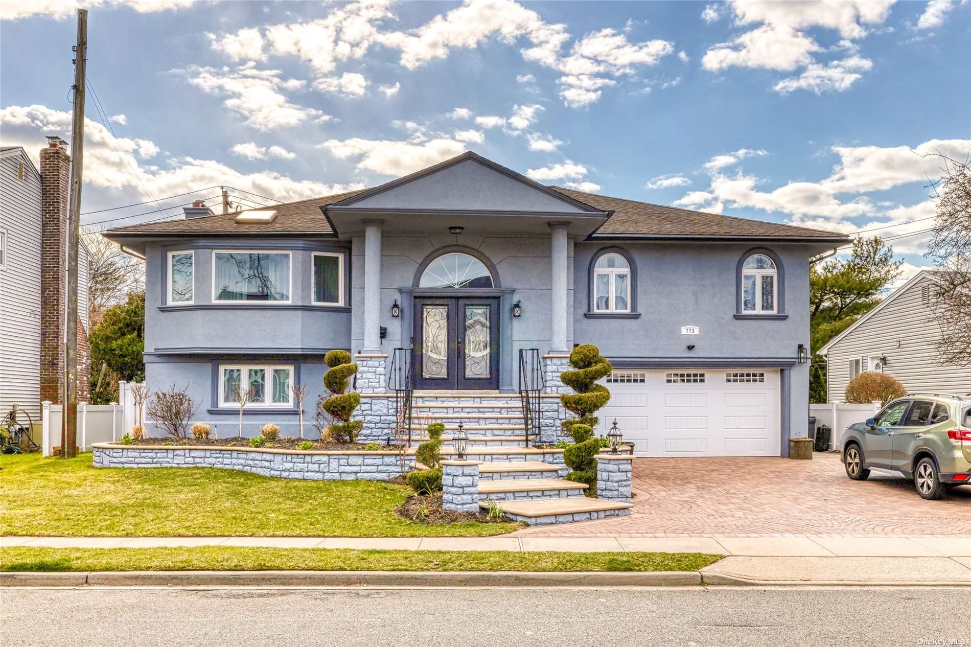 a front view of a house with swimming pool and outdoor seating