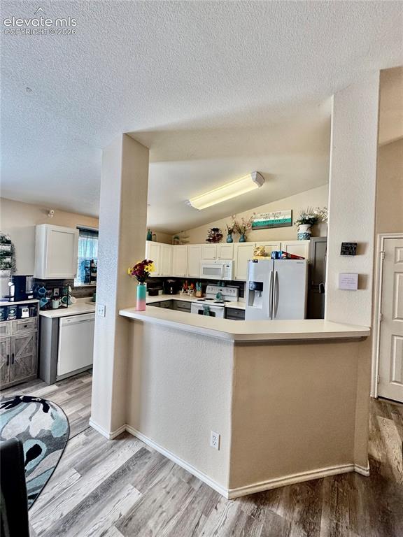 3748 Riviera Grove, Unit 203 Colorado Springs, CO 80922 - Photo 5 of 23 a kitchen with stainless steel appliances granite countertop a refrigerator and a stove top oven