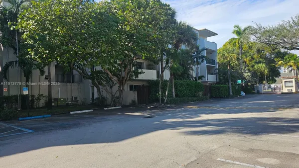 a view of a house with a tree in front