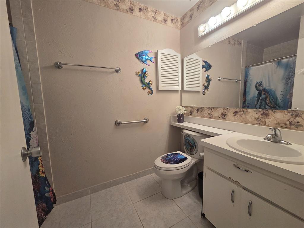 4059 Ligonier Road Spring Hill, FL 34608 - Photo 15 of 36 a bathroom with a sink and a mirror