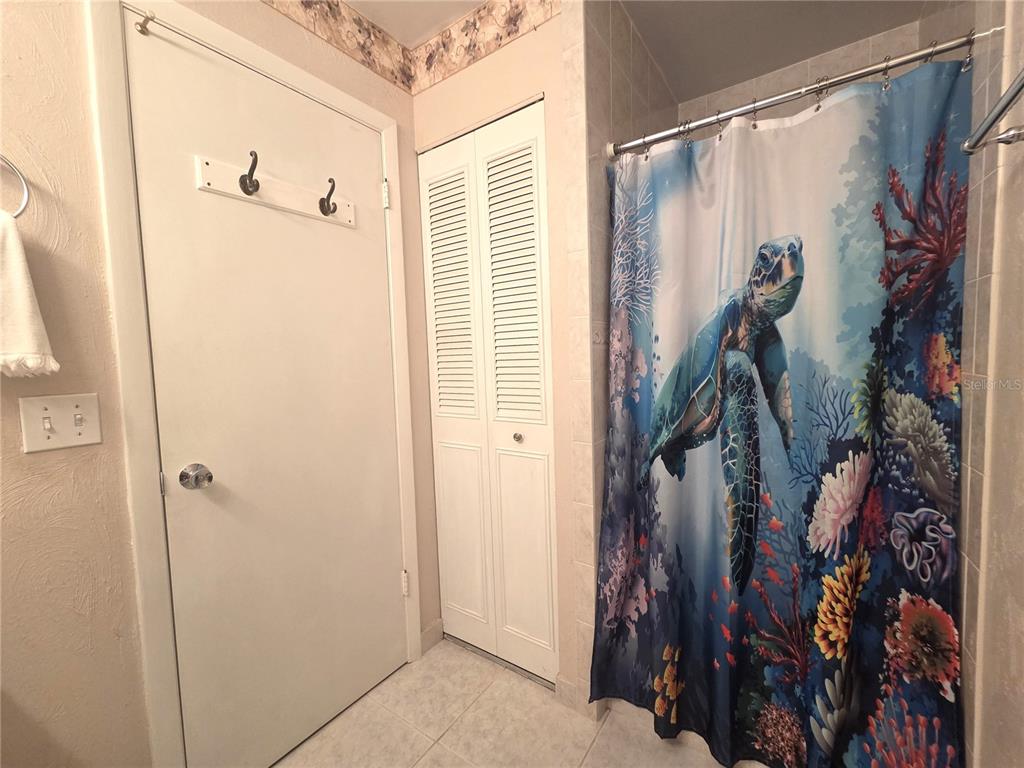 4059 Ligonier Road Spring Hill, FL 34608 - Photo 16 of 36 a view of walk in closet with clothes and shoes