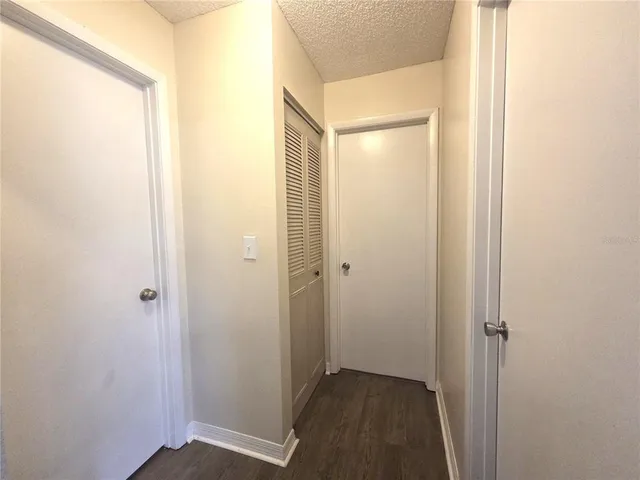 a view of hallway with closet area