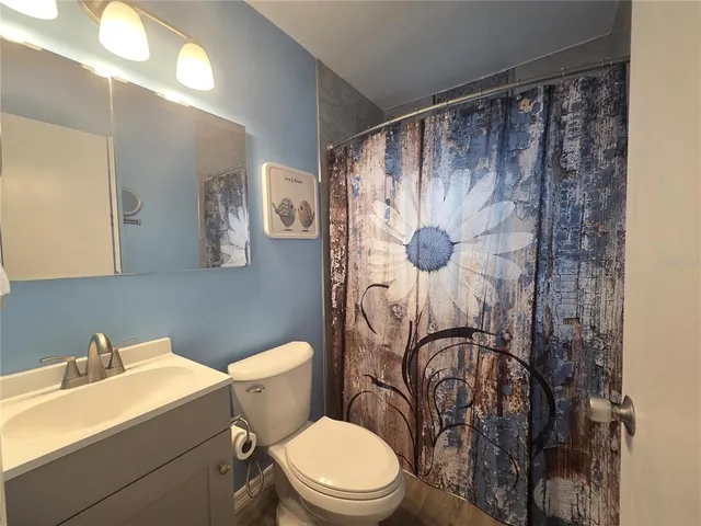 a white toilet sitting next to a bathroom sink