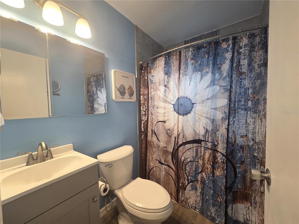 4059 Ligonier Road Spring Hill, FL 34608 - Photo 20 of 36 a white toilet sitting next to a bathroom sink