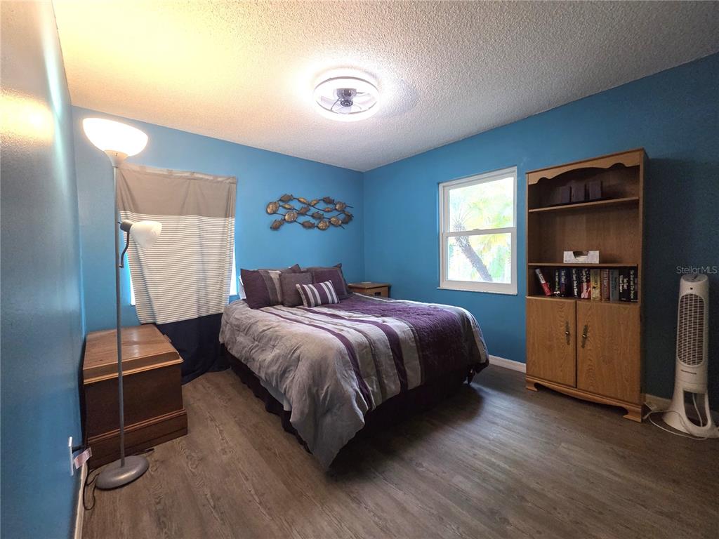 4059 Ligonier Road Spring Hill, FL 34608 - Photo 21 of 36 a bedroom with a bed and wooden floor