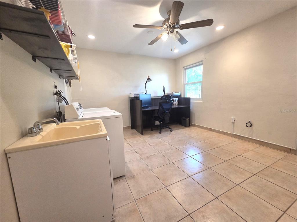 4059 Ligonier Road Spring Hill, FL 34608 - Photo 24 of 36 a living room with a couch and a chandelier