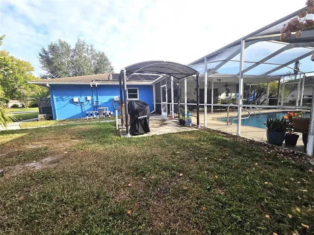 a view of a house with a yard patio and sitting area