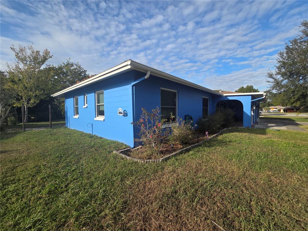 4059 Ligonier Road Spring Hill, FL 34608 - Photo 33 of 36 a backyard of a house with plants and large tree