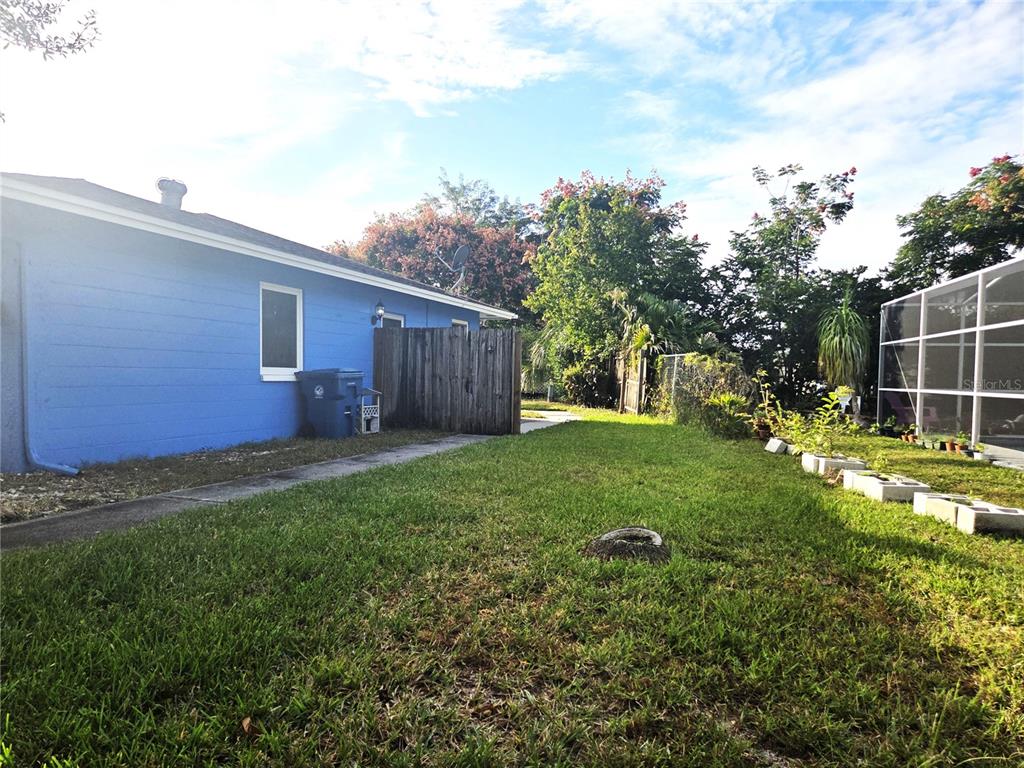 4059 Ligonier Road Spring Hill, FL 34608 - Photo 34 of 36 a view of a backyard with plants and large trees