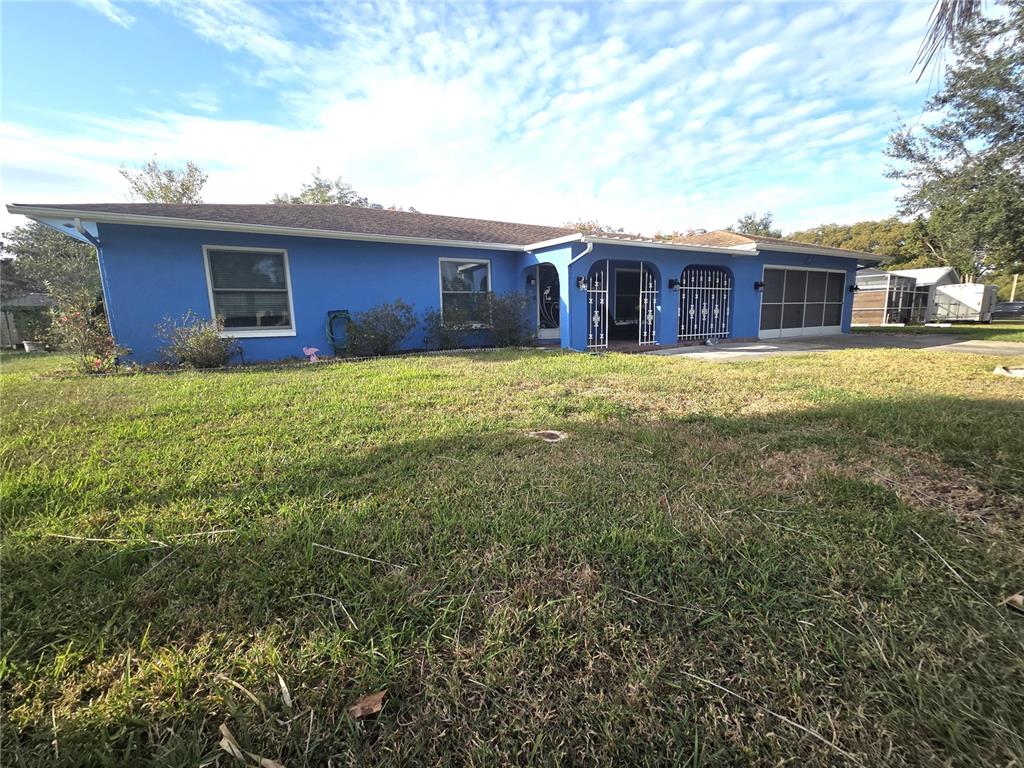 4059 Ligonier Road Spring Hill, FL 34608 - Photo 36 of 36 a view of a house with a yard