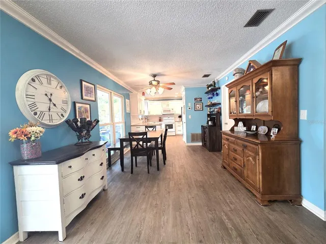 a kitchen with furniture a stove and a wooden floors