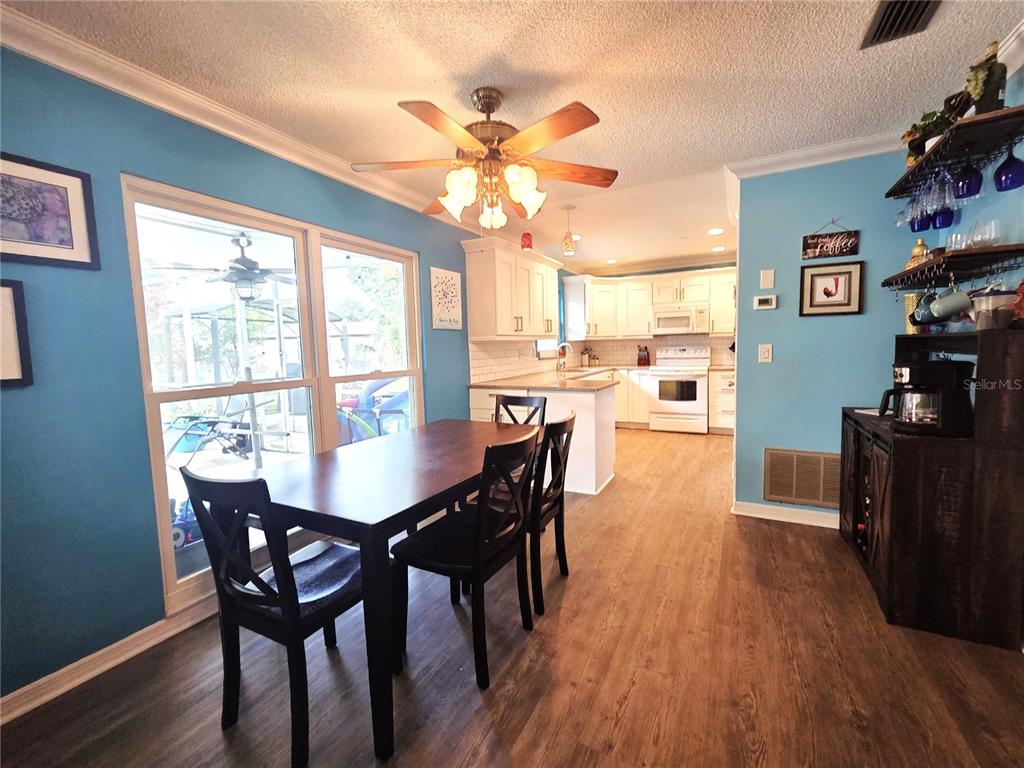 4059 Ligonier Road Spring Hill, FL 34608 - Photo 6 of 36 a view of a dining room with furniture window and wooden floor