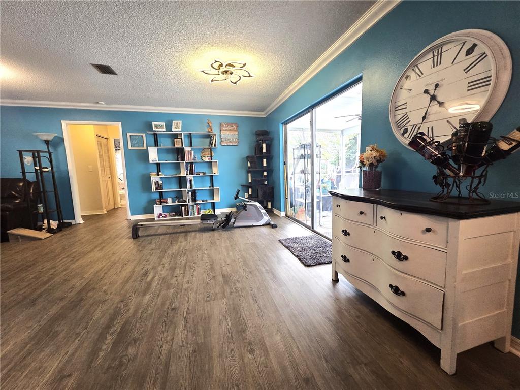 4059 Ligonier Road Spring Hill, FL 34608 - Photo 8 of 36 a living room with furniture and a flat screen tv